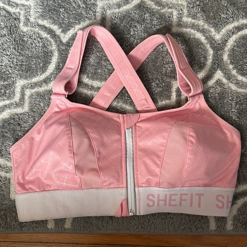 SHEFIT pink and white sports bra.